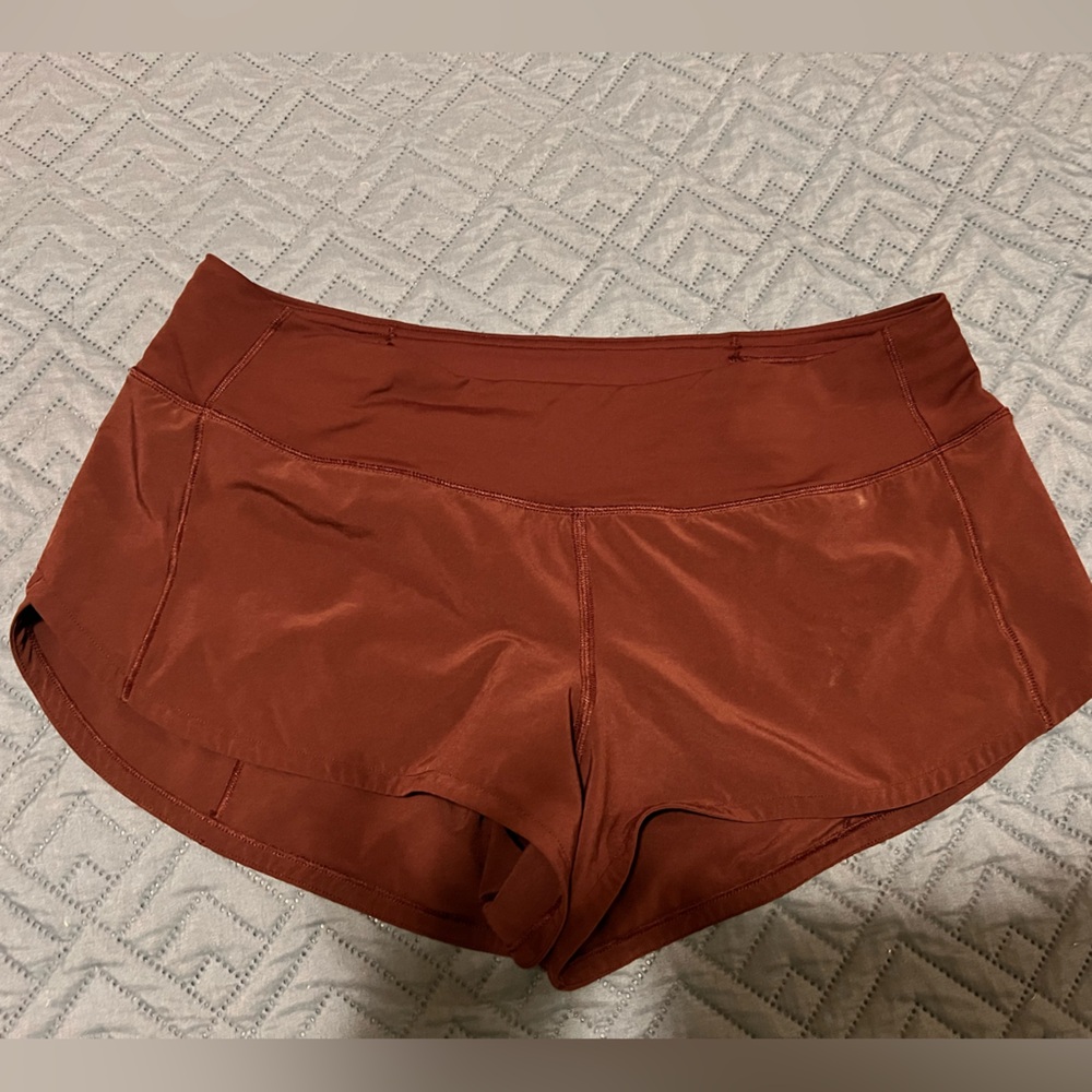 Lululemon Speed Up Low-Rise Lined Short 2.5" shorts are maroon in color.